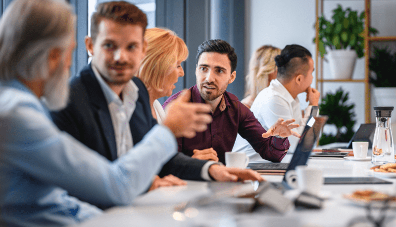 business team meeting sitting at a board table