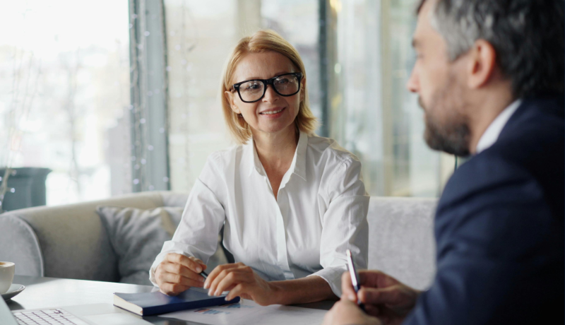 woman and man sitting in business meeting