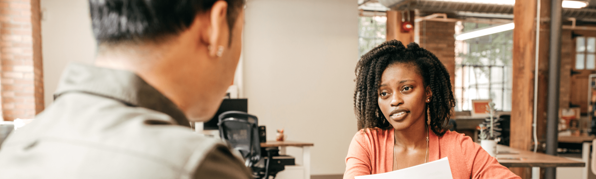 Woman looking at a man in the foreground out of focus